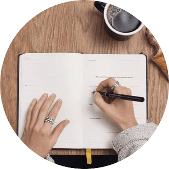 person writing on a planner | Host Family Stay