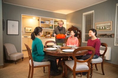 Host family serving dinner to guest student staying at their home | Host Family Stay
